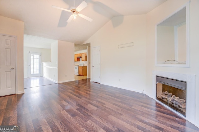 unfurnished living room with ceiling fan, lofted ceiling, and dark wood-type flooring