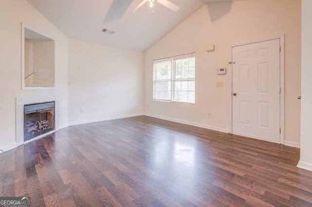 unfurnished living room featuring ceiling fan, dark wood-type flooring, and vaulted ceiling