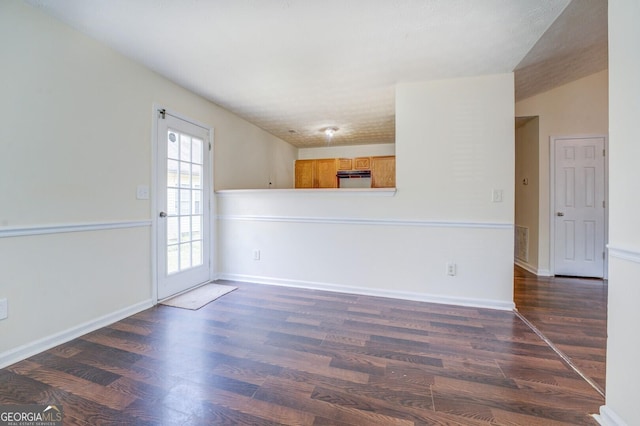 spare room with dark hardwood / wood-style flooring