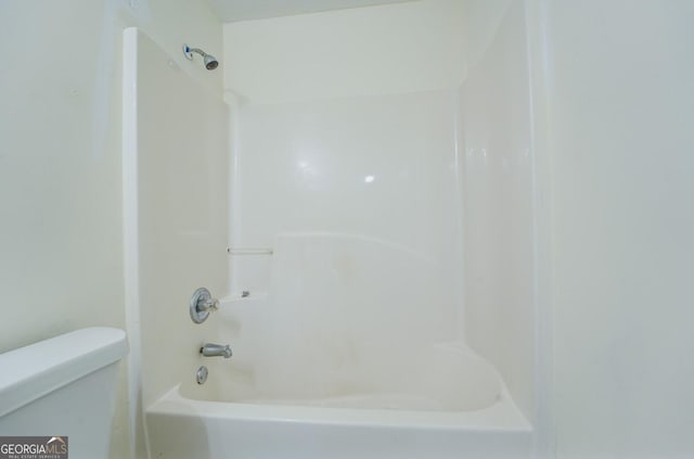 bathroom featuring  shower combination and toilet