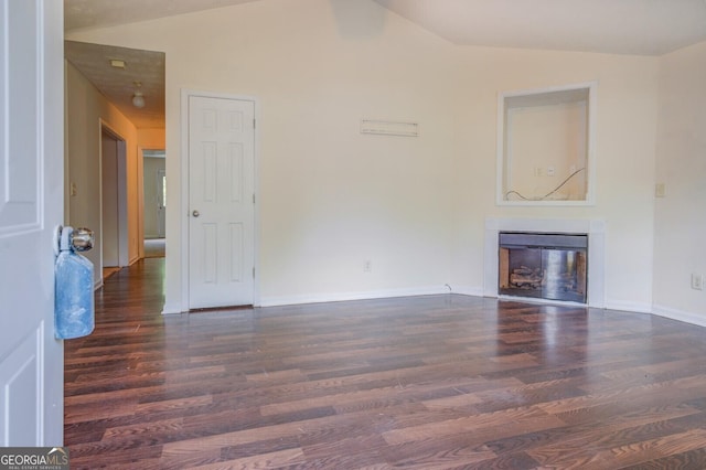 unfurnished living room with dark hardwood / wood-style floors and vaulted ceiling