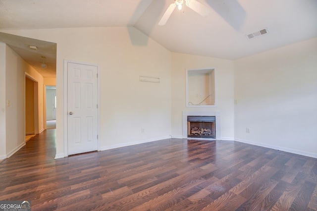 unfurnished living room featuring ceiling fan, dark hardwood / wood-style flooring, and vaulted ceiling