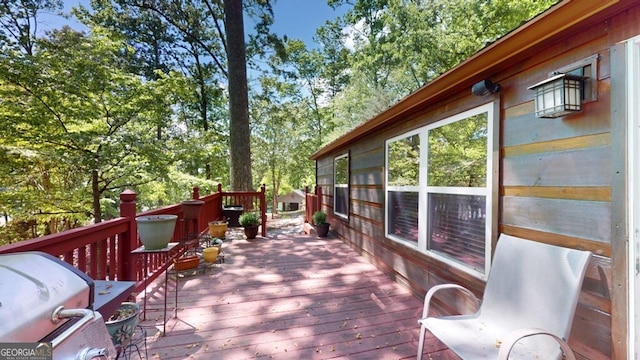 wooden deck featuring a grill