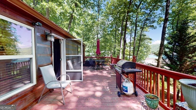 wooden terrace featuring a grill