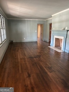 unfurnished living room with ornamental molding and dark wood-type flooring