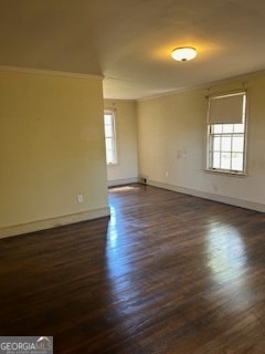 unfurnished room with ornamental molding and dark hardwood / wood-style flooring