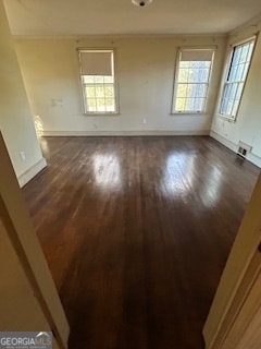 unfurnished room with dark wood-type flooring