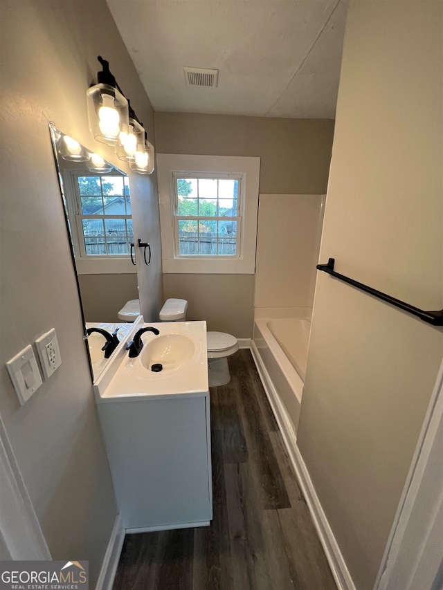 full bathroom featuring shower / tub combination, wood-type flooring, toilet, and vanity