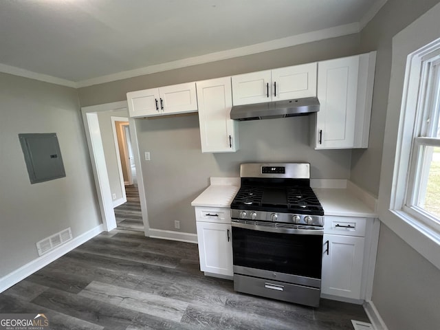 kitchen with white cabinetry, ornamental molding, dark wood-type flooring, and stainless steel range with gas cooktop