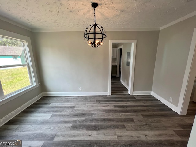 unfurnished dining area with a wealth of natural light, dark hardwood / wood-style flooring, and a textured ceiling