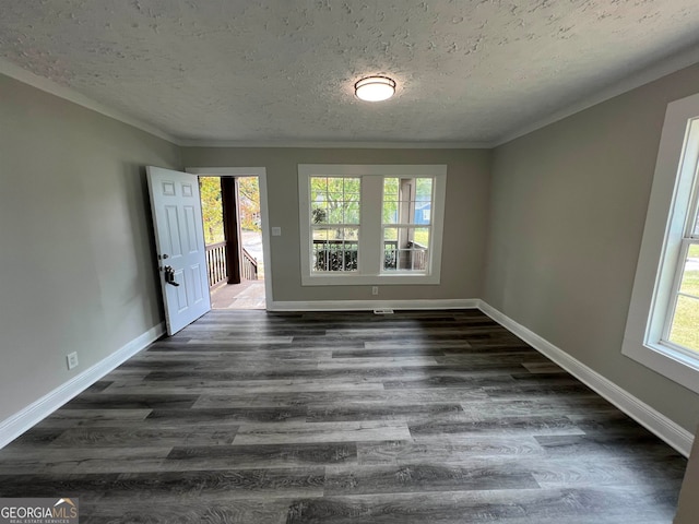 spare room featuring a textured ceiling and dark wood-type flooring