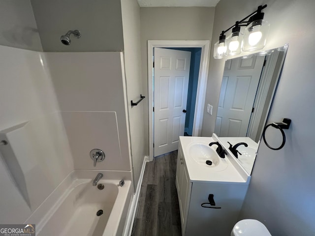 bathroom featuring wood-type flooring, vanity, and bathing tub / shower combination