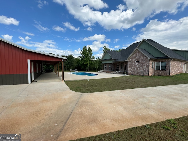 view of pool with a lawn