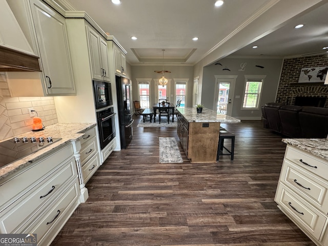 kitchen featuring premium range hood, dark hardwood / wood-style flooring, backsplash, and black appliances