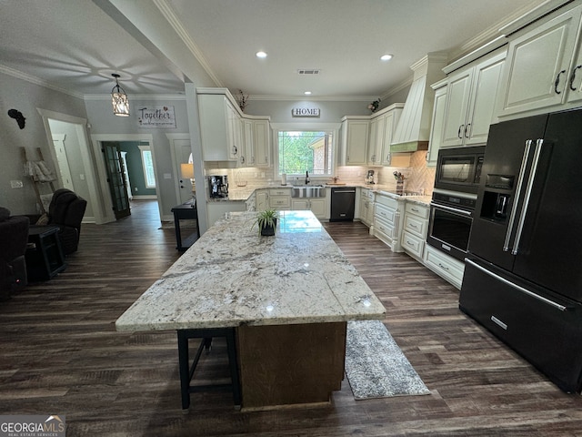 kitchen with dark wood-type flooring, custom exhaust hood, black appliances, and tasteful backsplash