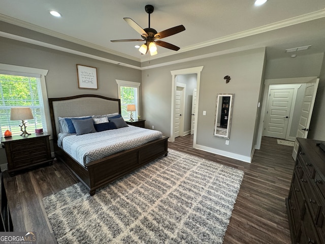 bedroom with dark hardwood / wood-style flooring, ornamental molding, ceiling fan, and multiple windows