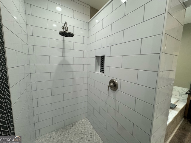 bathroom with a tile shower