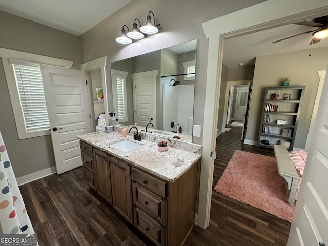 bathroom featuring wood-type flooring, vanity, and ceiling fan