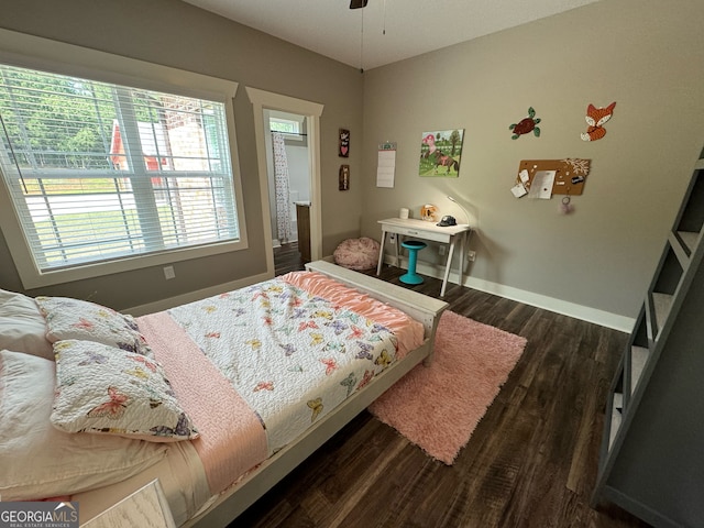 bedroom with ceiling fan and dark hardwood / wood-style flooring