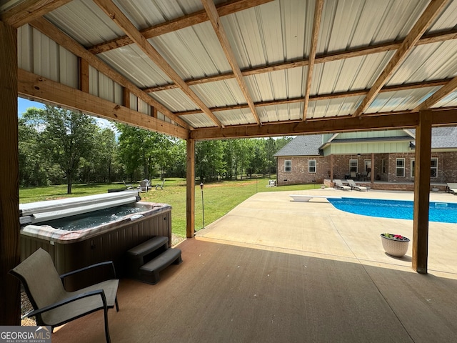 view of terrace with a swimming pool with hot tub