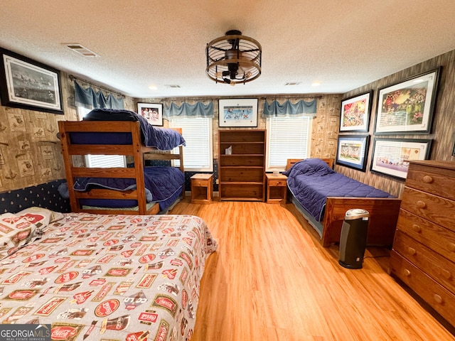 bedroom featuring hardwood / wood-style floors and a textured ceiling