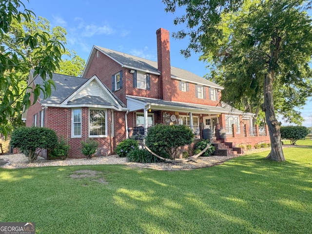 view of front of home featuring covered porch and a front lawn