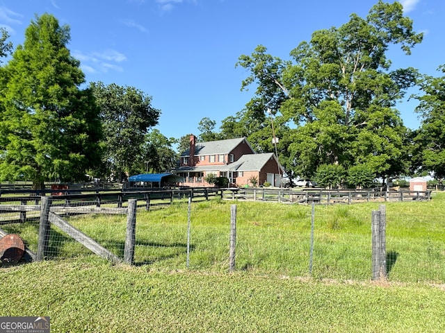 view of yard with a rural view