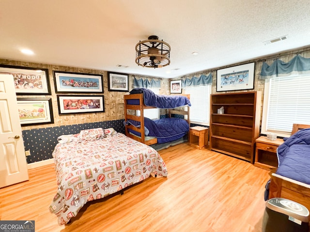 bedroom with hardwood / wood-style floors and a textured ceiling