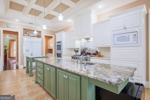 kitchen featuring white cabinets, crown molding, green cabinetry, and built in appliances