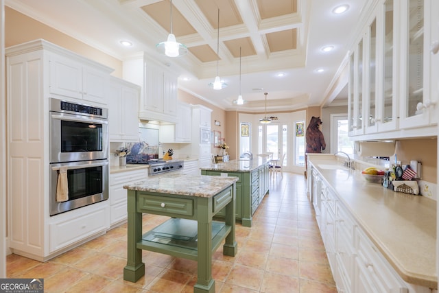 kitchen with crown molding, stainless steel appliances, white cabinets, and pendant lighting