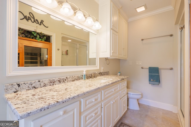 bathroom with crown molding, tile floors, toilet, and vanity with extensive cabinet space