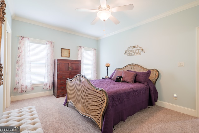 carpeted bedroom with ornamental molding and ceiling fan