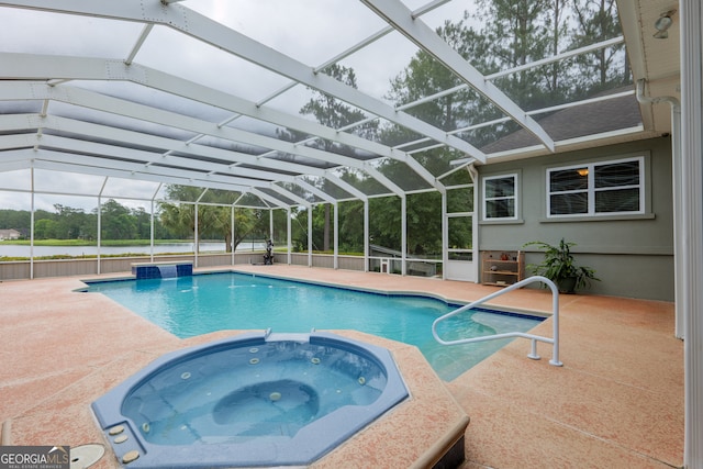 view of swimming pool featuring a patio area, a lanai, and an in ground hot tub