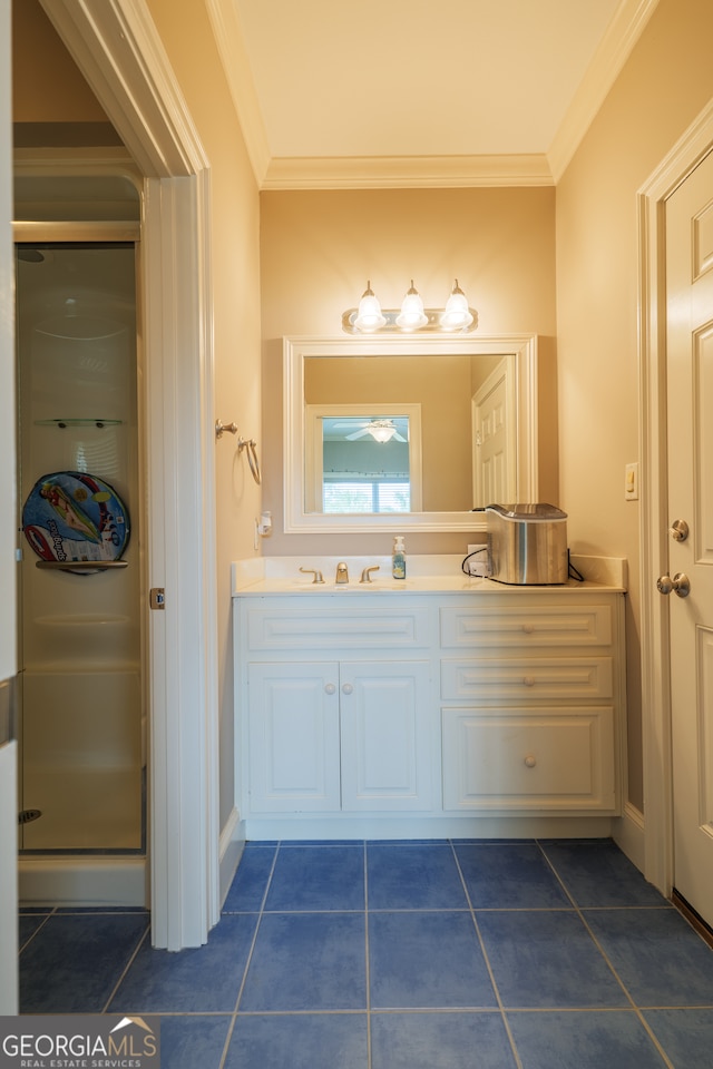 bathroom with tile flooring, an enclosed shower, vanity, and crown molding