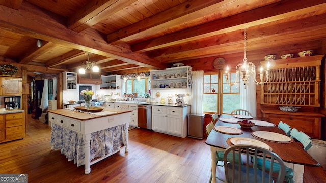 kitchen with white cabinetry, beam ceiling, a chandelier, pendant lighting, and stainless steel dishwasher