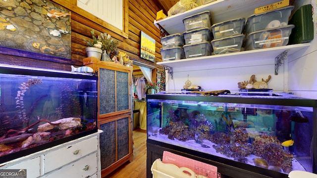 interior details featuring rustic walls and hardwood / wood-style floors