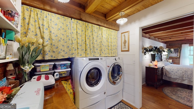 laundry room featuring wooden ceiling, hardwood / wood-style floors, wooden walls, and washing machine and clothes dryer