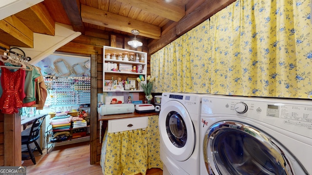 laundry area with washing machine and dryer, wood ceiling, and light wood-type flooring