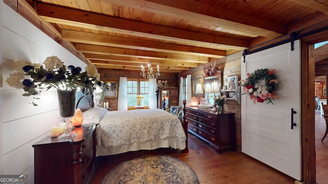 bedroom with a barn door, wood walls, beam ceiling, wood ceiling, and dark hardwood / wood-style flooring