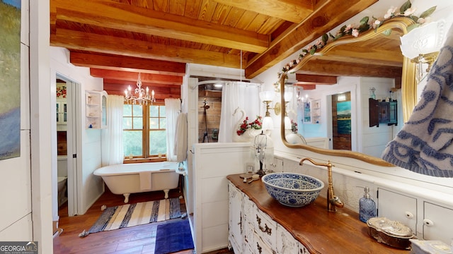 bathroom with toilet, beam ceiling, wood-type flooring, sink, and a chandelier