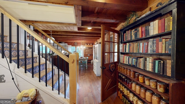 corridor with beam ceiling, hardwood / wood-style floors, and wooden ceiling