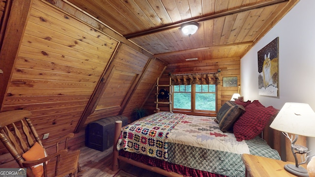 bedroom with hardwood / wood-style flooring, wooden ceiling, vaulted ceiling, and wood walls