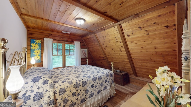 bedroom featuring lofted ceiling with beams, wood ceiling, and hardwood / wood-style flooring