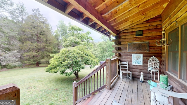 wooden deck featuring a yard