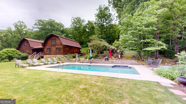 view of pool featuring a lawn and a patio