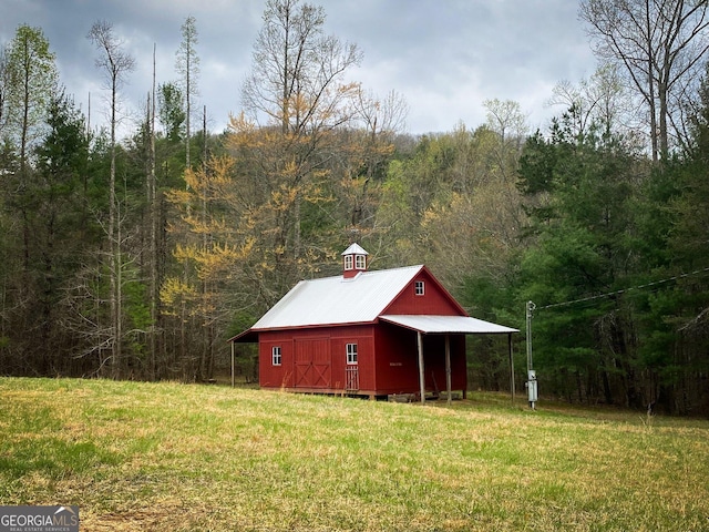 view of outbuilding featuring a yard