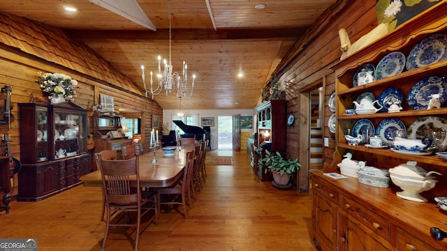 dining area featuring vaulted ceiling, wooden ceiling, a chandelier, and light hardwood / wood-style flooring