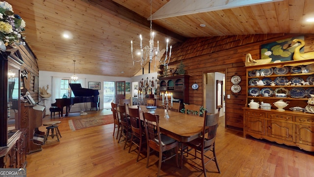 dining area featuring wooden ceiling, vaulted ceiling with beams, light hardwood / wood-style flooring, and wooden walls