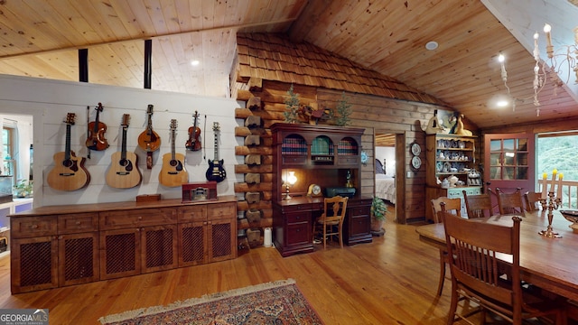 dining space with lofted ceiling, wooden walls, light hardwood / wood-style floors, and wooden ceiling