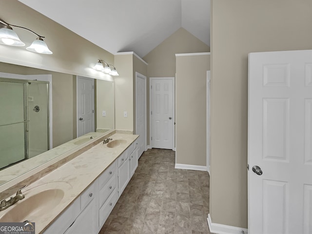 bathroom featuring vanity with extensive cabinet space, dual sinks, tile floors, a shower with shower door, and lofted ceiling